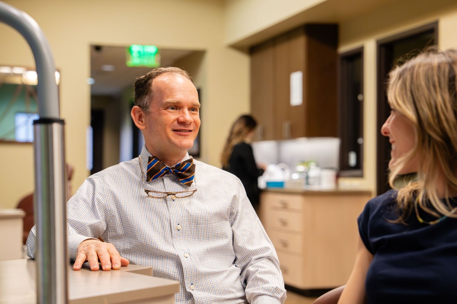 Dr. Larry Layfield smiling in his bow tie in the treatment area at New Braunfels Orthodontic Associates, a practice offering New Braunfels orthodontics